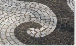 Curved mosaic pavement. Carrara and basalt with permanent joint PF1.