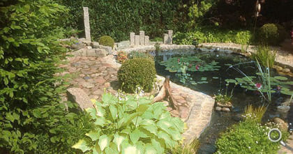 Natural pond with goldfish and design elements of stone.